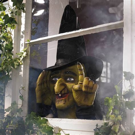 Halloween themed window decoration with tapping witch